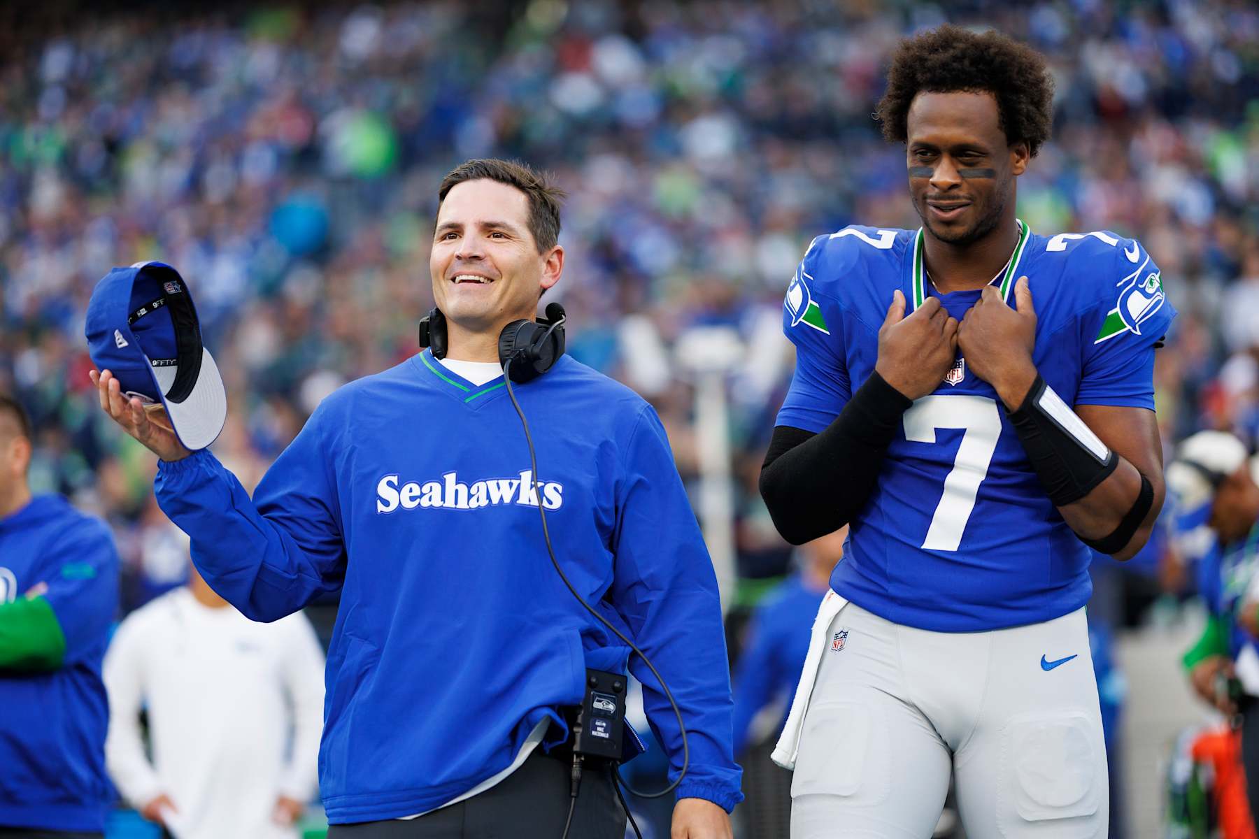SEATTLE, WASHINGTON - OCTOBER 10: Quarterback Geno Smith #7 of the Seattle Seahawks and head coach Mike Macdonald interact on the sidelines prior to an NFL football game against the San Francisco 49ers, at Lumen Field on October 10, 2024 in Seattle, Washington. (Photo by Brooke Sutton/Getty Images)