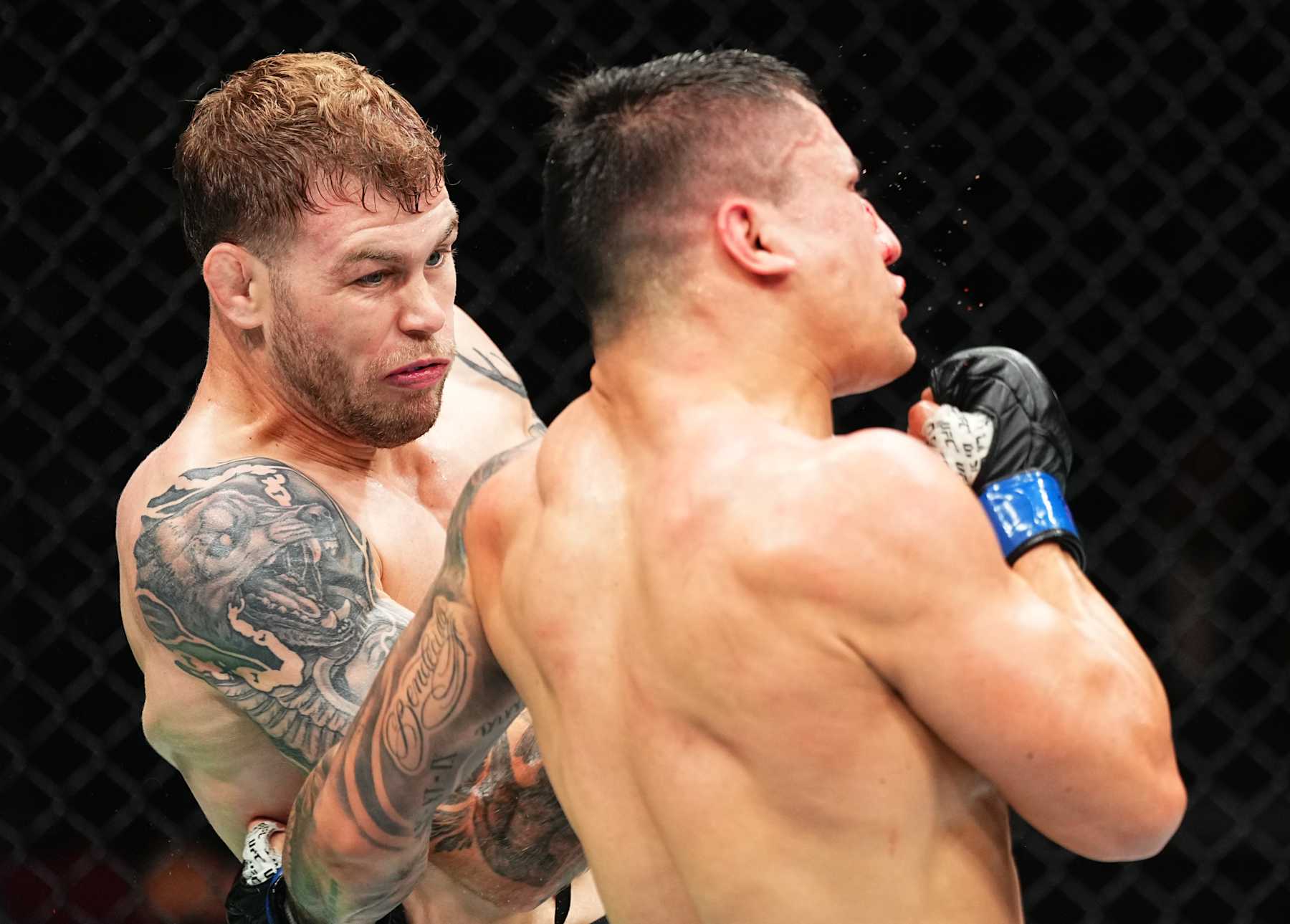 SYDNEY, AUSTRALIA - FEBRUARY 09: (L-R) Jake Matthews of Australia punches Francisco Prado of Argentina in a welterweight fight during the UFC 312 event at Qudos Bank Arena on February 09, 2025 in Sydney, Australia. (Photo by Jeff Bottari/Zuffa LLC)