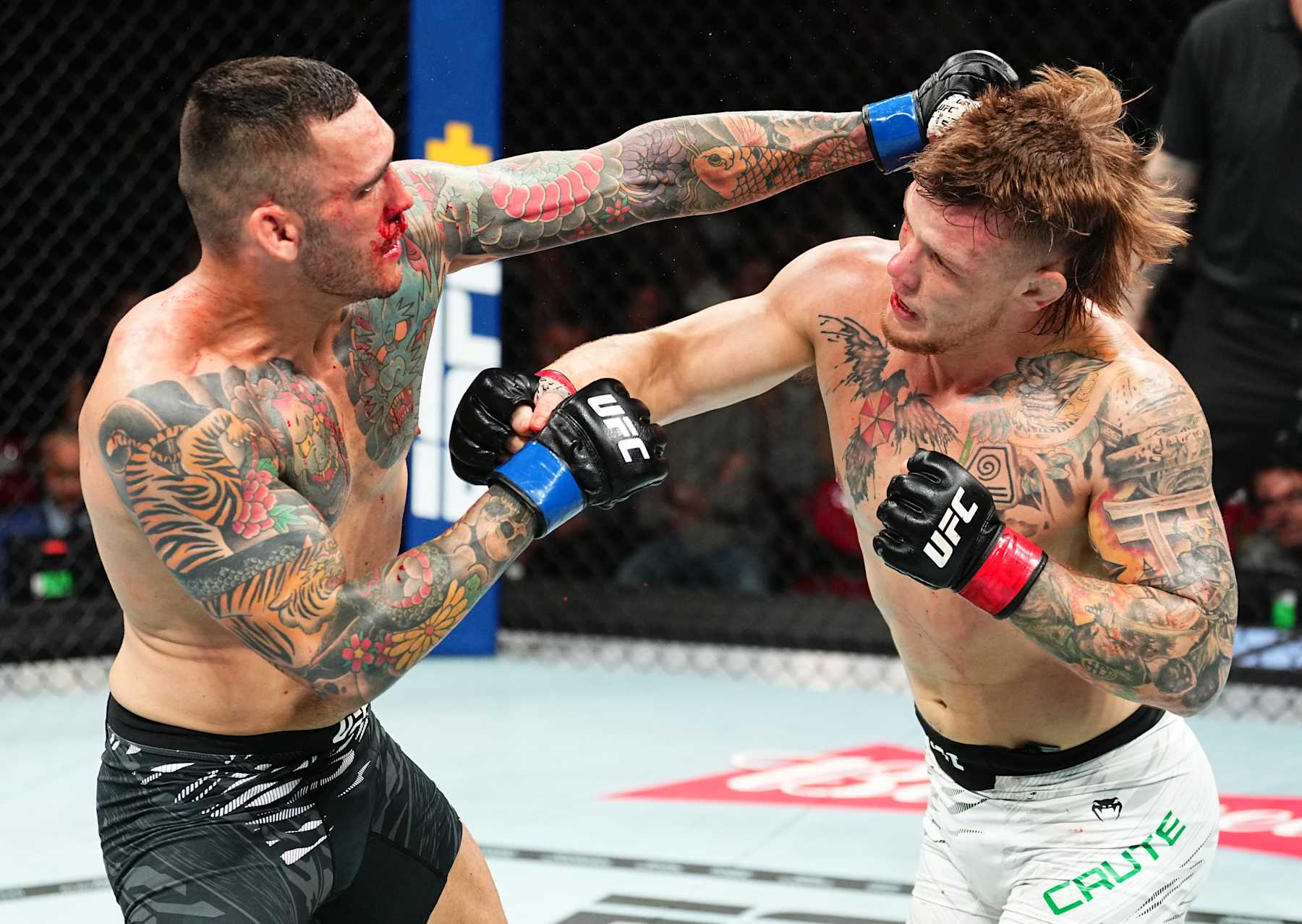 SYDNEY, AUSTRALIA - FEBRUARY 09: (L-R) Rodolfo Bellato of Brazil punches Jimmy Crute of Australia in a light heavyweight fight during the UFC 312 event at Qudos Bank Arena on February 09, 2025 in Sydney, Australia. (Photo by Jeff Bottari/Zuffa LLC)