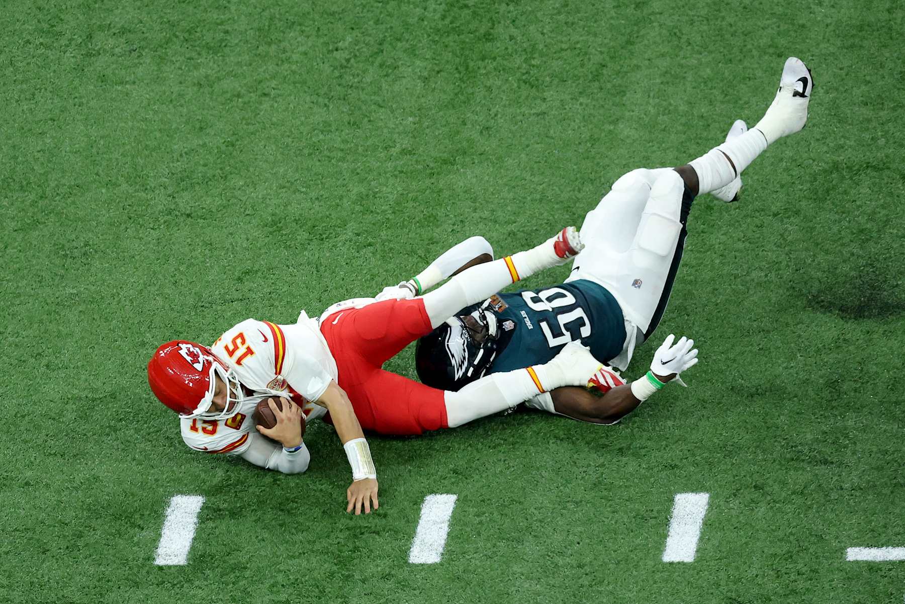 NEW ORLEANS, LOUISIANA - FEBRUARY 09: Patrick Mahomes #15 of the Kansas City Chiefs is sacked by Jalyx Hunt #58 of the Philadelphia Eagles in the third quarter during Super Bowl LIX at Caesars Superdome on February 09, 2025 in New Orleans, Louisiana. (Photo by Patrick Smith/Getty Images)