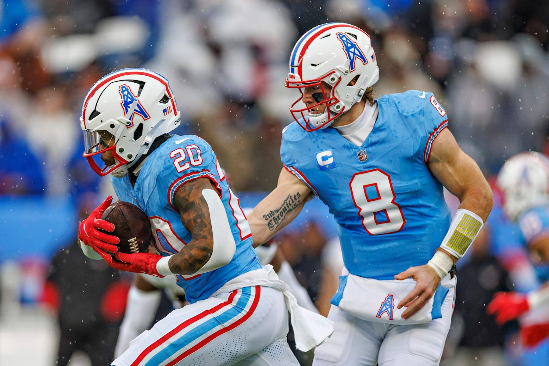 NASHVILLE, TENNESSEE - JANUARY 5: Will Levis #8 hands off the ball to Tony Pollard #20 of the Tennessee Titans during a game against the Houston Texans at Nissan Stadium on January 5, 2025 in Nashville, Tennessee. The Texans defeated the Titans 23-14. (Photo by Wesley Hitt/Getty Images)