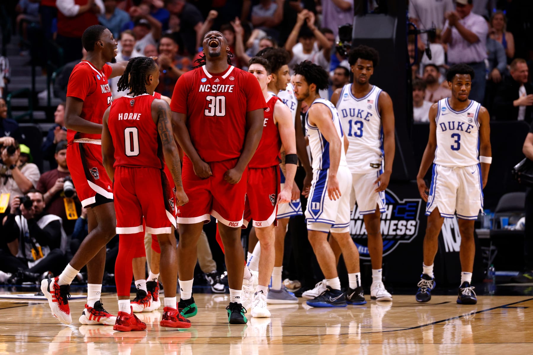 DALLAS, TEXAS - MARCH 31: DJ Burns Jr. #30 of the NC State Wolfpack reacts during the second half against the Duke Blue Devils in the Elite 8 round of the NCAA Men's Basketball Tournament at American Airlines Center on March 31, 2024 in Dallas, Texas. (Photo by Lance King/Getty Images)