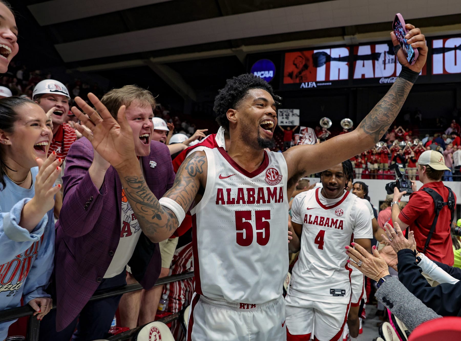 TUSCALOOSA, ALABAMA - FEBRUARY 21: Aaron Estrada #55 of the Alabama Crimson Tide celebrates a big win over the Florida Gators with the University of Alabama student section at Coleman Coliseum on February 21, 2024 in Tuscaloosa, Alabama. (Photo by Brandon Sumrall/Getty Images)