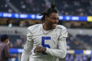 Rapper YG wears the jersey of Los Angeles Rams wide receiver Robert Woods  during the second half of an NFL football game against the Detroit Lions  Sunday, Oct. 24, 2021, in Inglewood