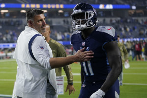 INGLEWOOD, CA - NOVEMBER 7: Tennessee Titans running back Adrian Peterson  #8 father Nelson Peterson holds up his son game worn jersey after the  Tennessee Titans game versus the Los Angeles Rams