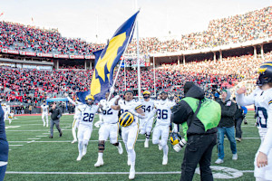 Video: Sherrone Moore Trolls Ohio State with Flag-Plant Gesture at Michigan CBB Game