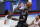 Brooklyn Nets' Kyrie Irving, center, shoots over New York Knicks' Julius Randle, left, and Elfrid Paytonduring the first half of an NBA basketball game Monday, April 5, 2021, in New York. (AP Photo/Frank Franklin II)