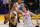 Los Angeles Lakers guard Talen Horton-Tucker, left, shoots as Houston Rockets forward Kelly Olynyk defends during the first half of an NBA basketball game Wednesday, May 12, 2021, in Los Angeles. (AP Photo/Mark J. Terrill)