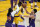 Phoenix Suns guard Devin Booker, right, commits a flagrant foul on Los Angeles Lakers guard Dennis Schroder, center, during the second half in Game 3 of an NBA basketball first-round playoff series Thursday, May 27, 2021, in Los Angeles. Booker was ejected after the play. (AP Photo/Marcio Jose Sanchez)