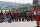 Teammates of 19 years-old Swiss rider Jason Dupasquier and riders from other teams stand near his motorbike as they pay a minute of silence in his memory prior to the start of the Motogp Grand Prix of Italy at the Mugello circuit, in Scarperia, Italy, Sunday, May 30, 2021. Dupasquier died Sunday after being hospitalized Saturday, at the Florence hospital following his crash during the qualifying practices of the Moto3. (AP Photo/Antonio Calanni)