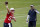 New England Patriots quarterback Mac Jones throws a pass as offensive coordinator Josh McDaniels looks on during NFL football practice in Foxborough, Mass., Friday, June 4, 2021. (AP Photo/Mary Schwalm)