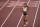 Katarina Johnson-Thompson, of Britain ambles towards the line after pulling up injured in the heptathlon 200-meters at the 2020 Summer Olympics, Wednesday, Aug. 4, 2021, in Tokyo, Japan. (AP Photo/Charlie Riedel)