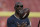 Former NFL wide receiver Terrell Owens flips a football before an NFL football game between the Tampa Bay Buccaneers and the Indianapolis Colts Sunday, Dec. 8, 2019, in Tampa, Fla. (AP Photo/Chris O'Meara)