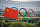 A Chinese flag flutters in front of the IOC headquarters during a protest by activists of the International Tibet Network against the Beijing 2022 Winter Olympics on Februay 3, 2021 in Lausanne. - A coalition of campaign groups issued an open letter calling on world leaders to boycott the Beijing 2022 Winter Olympics over China's rights record. The Games are scheduled to begin on February 4 next year, just six months after the delayed summer Tokyo Olympics, but preparations have been overshadowed by the coronavirus pandemic. (Photo by Fabrice COFFRINI / AFP) (Photo by FABRICE COFFRINI/AFP via Getty Images)