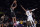 Brooklyn Nets guard Cam Thomas, center, shoots as Los Angeles Lakers guard Wayne Ellington defends during the first half of a preseason NBA basketball game Sunday, Oct. 3, 2021, in Los Angeles. (AP Photo/Mark J. Terrill)