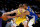 Los Angeles Lakers guard Mac McClung, left, is defended by Golden State Warriors guard Avery Bradley during the second half of a preseason NBA basketball game in Los Angeles, Tuesday, Oct. 12, 2021. (AP Photo/Ringo H.W. Chiu)