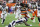 Cleveland Browns running back D'Ernest Johnson (30) jumps over Denver Broncos safety Kareem Jackson (22) during the first half of an NFL football game Thursday, Oct. 21, 2021, in Cleveland. (AP Photo/Ron Schwane)