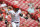 Cincinnati Reds' Nick Castellanos watches as he hits a sacrifice fly during the first inning of a baseball game against the Pittsburgh Pirates in Cincinnati, Monday, Sept. 27, 2021. (AP Photo/Aaron Doster)