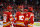 CALGARY, AB - DECEMBER 11: Calgary Flames Center Elias Lindholm (28), Calgary Flames Defenceman Noah Hanifin (55) and Calgary Flames Defenceman Rasmus Andersson (4) talk strategy during the second period of an NHL game where the Calgary Flames hosted the Boston Bruins on December 11, 2021, at the Scotiabank Saddledome in Calgary, AB. (Photo by Brett Holmes/Icon Sportswire via Getty Images)