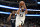 Minnesota Timberwolves center Karl-Anthony Towns, front, looks to make a pass in front of Dallas Mavericks forward Marquese Chriss, rear, in the second half of an NBA basketball game in Dallas, Tuesday, Dec. 21, 2021. (AP Photo/Matt Strasen)