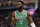 Boston Celtics guard Jaylen Brown (7) reacts after chipping his tooth on a play against the Milwaukee Bucks during the first half of an NBA basketball game Saturday, Dec. 25, 2021, in Milwaukee. (AP Photo/Jon Durr)