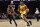 Atlanta Hawks forward Cam Reddish (22) drives past New York Knicks guard Kemba Walker during the first half of an NBA basketball game Saturday, Dec. 25, 2021, in New York. (AP Photo/Adam Hunger)