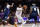 Los Angeles Lakers forward LeBron James (6) drives between Minnesota Timberwolves center Naz Reid (11) and Jarred Vanderbilt (8) during the first half of an NBA basketball game in Los Angeles, Sunday, Jan. 2, 2022. (AP Photo/Ringo H.W. Chiu)