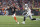 Cincinnati Bengals quarterback Joe Burrow (9) throws while being pressured by Las Vegas Raiders' Maxx Crosby (98) during the first half of an NFL wild-card playoff football game, Saturday, Jan. 15, 2022, in Cincinnati. (AP Photo/Jeff Dean)