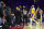 Los Angeles Lakers' Carmelo Anthony, top center, is held back by officials after having a word with a fan in the stands during the second half of an NBA basketball game against the Philadelphia 76ers, Thursday, Jan. 27, 2022, in Philadelphia. (AP Photo/Chris Szagola)