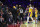 Los Angeles Lakers' Carmelo Anthony, center, gets held back by the officials after having words with a fan during the second half of an NBA basketball game, Thursday, Jan. 27, 2022, in Philadelphia. The 76ers won 105-87. (AP Photo/Chris Szagola)