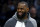 CHARLOTTE, NORTH CAROLINA - JANUARY 28: LeBron James #6 of the Los Angeles Lakers looks on from the sideline during the first half of the game against the Charlotte Hornets at Spectrum Center on January 28, 2022 in Charlotte, North Carolina. NOTE TO USER: User expressly acknowledges and agrees that, by downloading and or using this photograph, User is consenting to the terms and conditions of the Getty Images License Agreement. (Photo by Jared C. Tilton/Getty Images)
