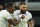 Real Madrid's David Alaba celebrates with Karim Benzema, right, who scored his side's first goal during the Champions League, round of 16, second leg soccer match between Real Madrid and Paris Saint-Germain at the Santiago Bernabeu stadium in Madrid, Spain, Wednesday, March 9, 2022. (AP Photo/Manu Fernandez)