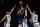 Brooklyn Nets guard Kyrie Irving (11) shoots from between Milwaukee Bucks' Giannis Antetokounmpo (34), Wesley Matthews (23) and Brook Lopez (11) during the first half of an NBA basketball game Thursday, March 31, 2022, in New York. (AP Photo/Noah K. Murray)
