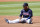 Cleveland Guardians third baseman Jose Ramirez sits on the infield dirt after failing to make a force out at second base against the Milwaukee Brewers during the third inning of a spring training baseball game Tuesday, March 29, 2022, in Goodyear, Ariz. (AP Photo/Ross D. Franklin)