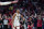 New Orleans Pelicans guard CJ McCollum (3) reacts with the crowd after scoring a 3-point basket in the first half of an NBA play-in basketball game against the San Antonio Spurs in New Orleans, Wednesday, April 13, 2022. (AP Photo/Gerald Herbert)