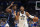 Dallas Mavericks forward Reggie Bullock (25) defends as Utah Jazz guard Donovan Mitchell (45) works to the basket in the first half of Game 1 of an NBA basketball first-round playoff series, Saturday, April 16, 2022, in Dallas. (AP Photo/Tony Gutierrez)