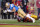 Los Angeles, CA - November 20:  UCLA wide receiver Kyle Philips dives into the end zone for a touchdown as USC safety Calen Bullock tries to stop him in the first quarter at Los Angeles Memorial Coliseum in Los Angeles on Saturday, Nov. 20, 2021. (Allen J. Schaben / Los Angeles Times via Getty Images)