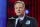 FILE - In this April 29, 2021, file photo, NFL commissioner Roger Goodell, wearing a COVID-19 vaccinated sticker, speaks during the first round of the NFL football draft in Cleveland. The NFL has informed teams they could potentially forfeit a game due to a COVID-19 outbreak among non-vaccinated players and players on both teams wouldn’t get paid that week. Commissioner Goodell said Thursday, July 22, 2021, in a memo sent to clubs that was obtained by The Associated Press that the league doesn’t anticipate adding a 19th week to accommodate games that can’t be rescheduled within the 18-week regular season. (AP Photo/Steve Luciano)