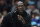 Michael Jordan looks on during the first half of an NBA basketball game between the Charlotte Hornets and the New York Knicks in Charlotte, N.C., Friday, Nov. 12, 2021. (AP Photo/Jacob Kupferman)