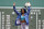 WWE wrestler Sasha Banks reacts before throwing out the first pitch before the start of baseball game between the Boston Red Sox and the Chicago White Sox at Fenway Park, Sunday, May 8, 2022, in Boston. (AP Photo/Mary Schwalm)