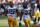 CINCINNATI, OHIO - OCTOBER 10: AJ Dillon #28 and Aaron Jones #33 of the Green Bay Packers walk off the field after beating the Cincinnati Bengals 25-22 in overtime at Paul Brown Stadium on October 10, 2021 in Cincinnati, Ohio. (Photo by Dylan Buell/Getty Images)
