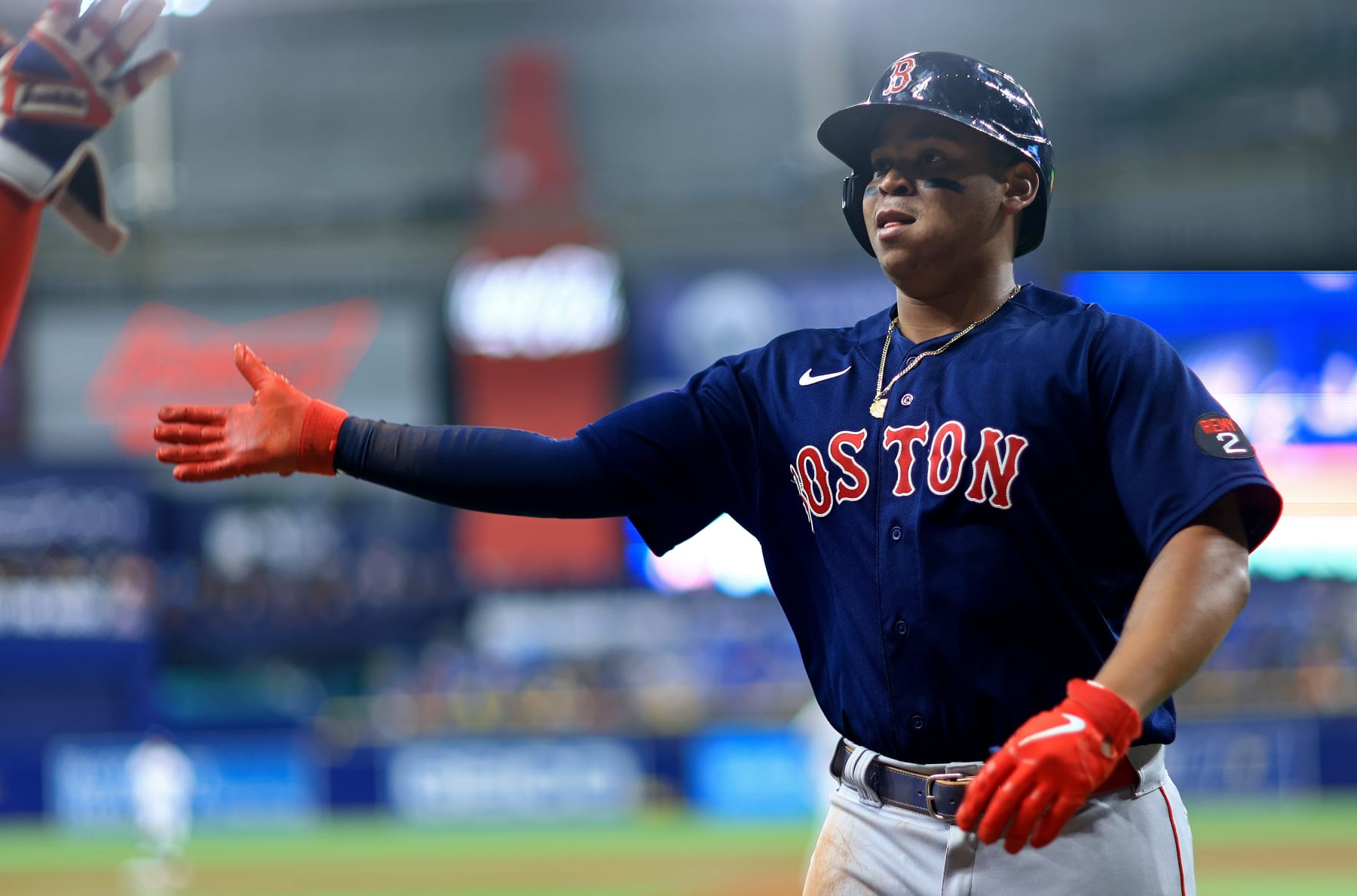 ST PETERSBURG, FLORIDA - JULY 14: Rafael Devers #11 of the Boston Red Sox is congratuladed after hitting a home run in the fourth inning during a game against the Tampa Bay Rays at Tropicana Field on July 14, 2022 in St Petersburg, Florida. (Photo by Mike Ehrmann/Getty Images)