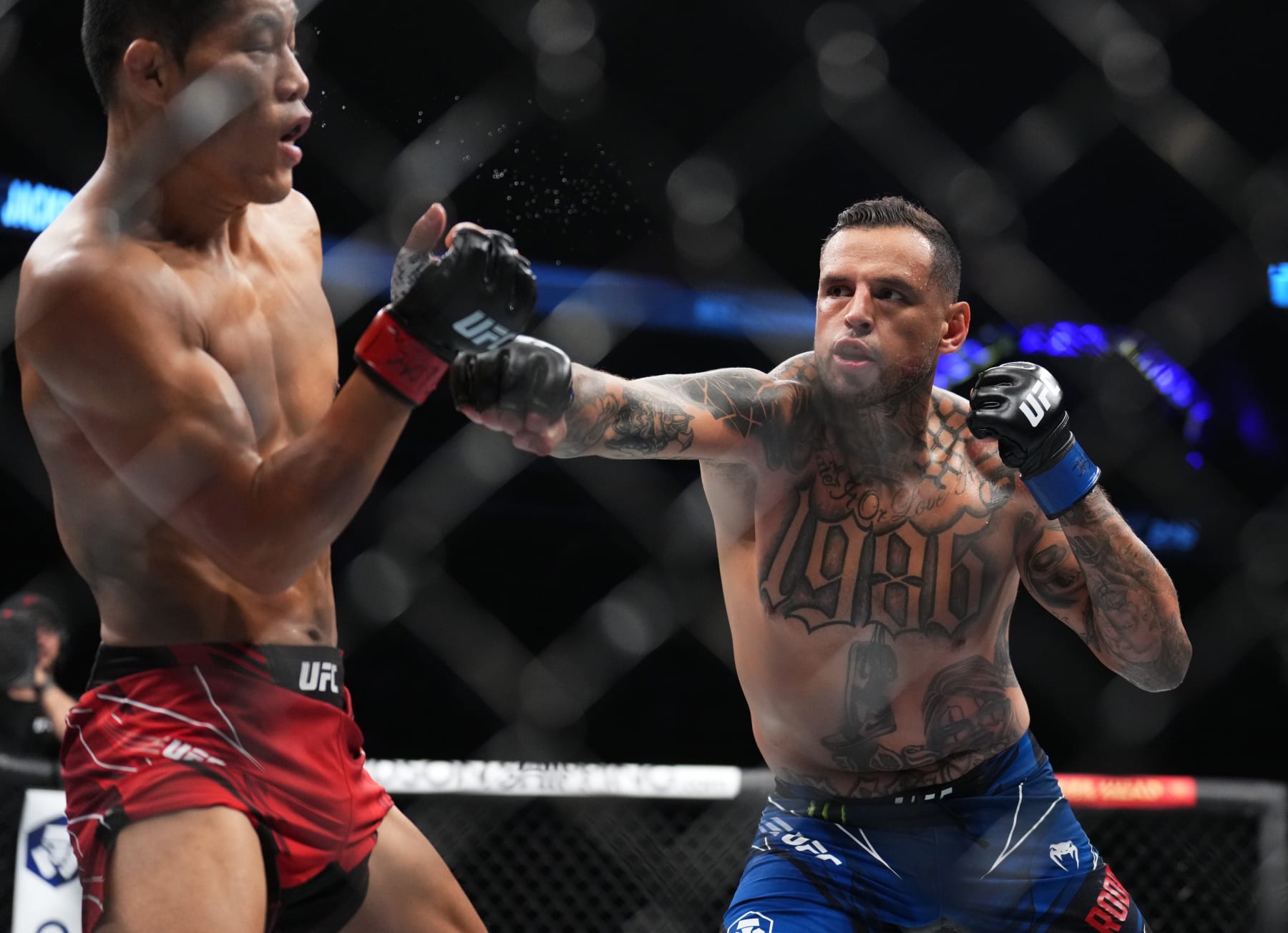 LAS VEGAS, NEVADA - SEPTEMBER 10: (R-L) Daniel Rodriguez punches Li Jingliang of China in a 180-pound catchweight fight during the UFC 279 event at T-Mobile Arena on September 10, 2022 in Las Vegas, Nevada. (Photo by Chris Unger/Zuffa LLC)