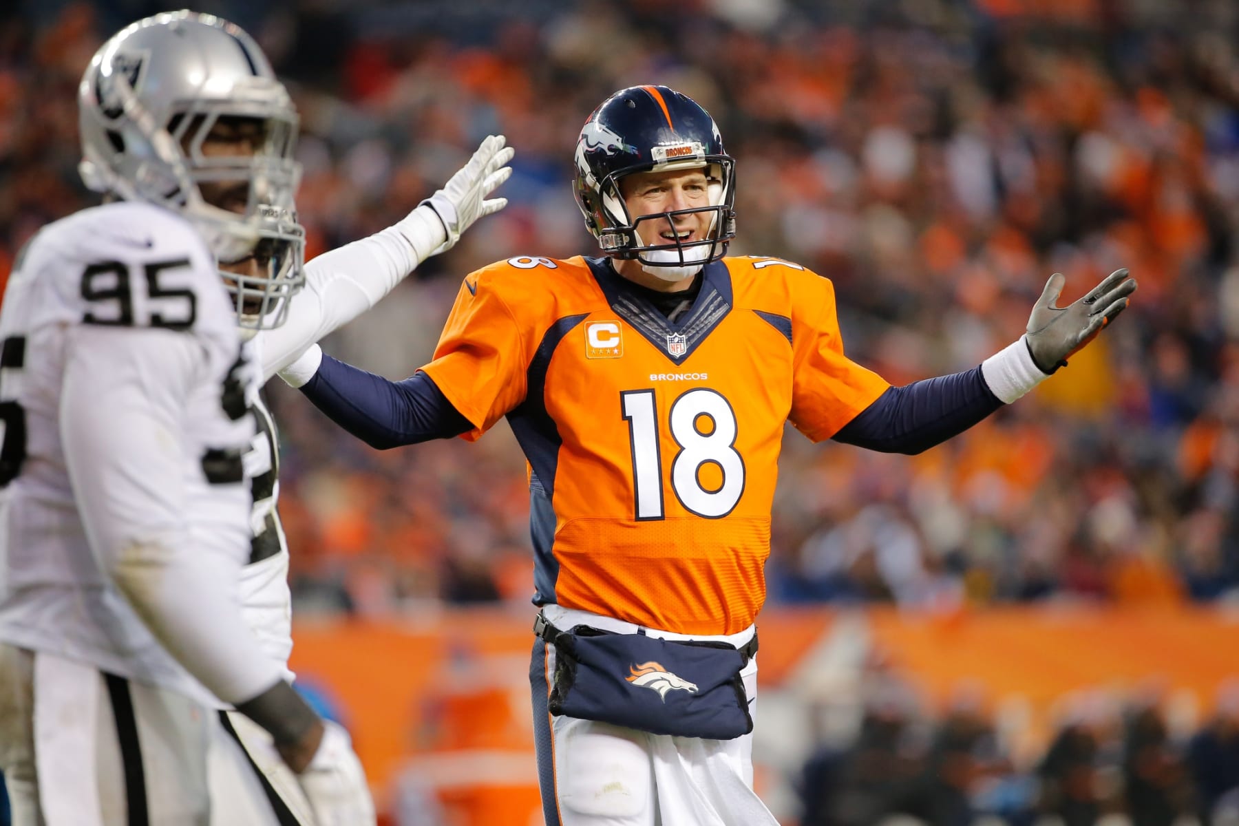 DENVER, CO - DECEMBER 28: Quarterback Peyton Manning #18 of the Denver Broncos protests the spot of the football on a call that would be reviewed and changed to a first down ruling during a game against the Oakland Raiders at Sports Authority Field at Mile High on December 28, 2014 in Denver, Colorado. (Photo by Doug Pensinger/Getty Images)