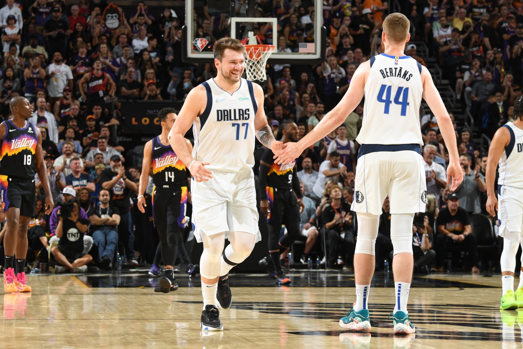 PHOENIX, AZ - MAY 10: Luka Doncic #77 of the Dallas Mavericks high fives Davis Bertans #44 of the Dallas Mavericks during Game 5 of the 2022 NBA Playoffs Western Conference Semifinals on May 10, 2022 at Footprint Center in Phoenix, Arizona. NOTE TO USER: User expressly acknowledges and agrees that, by downloading and or using this photograph, user is consenting to the terms and conditions of the Getty Images License Agreement. Mandatory Copyright Notice: Copyright 2022 NBAE (Photo by Andrew D. Bernstein/NBAE via Getty Images)