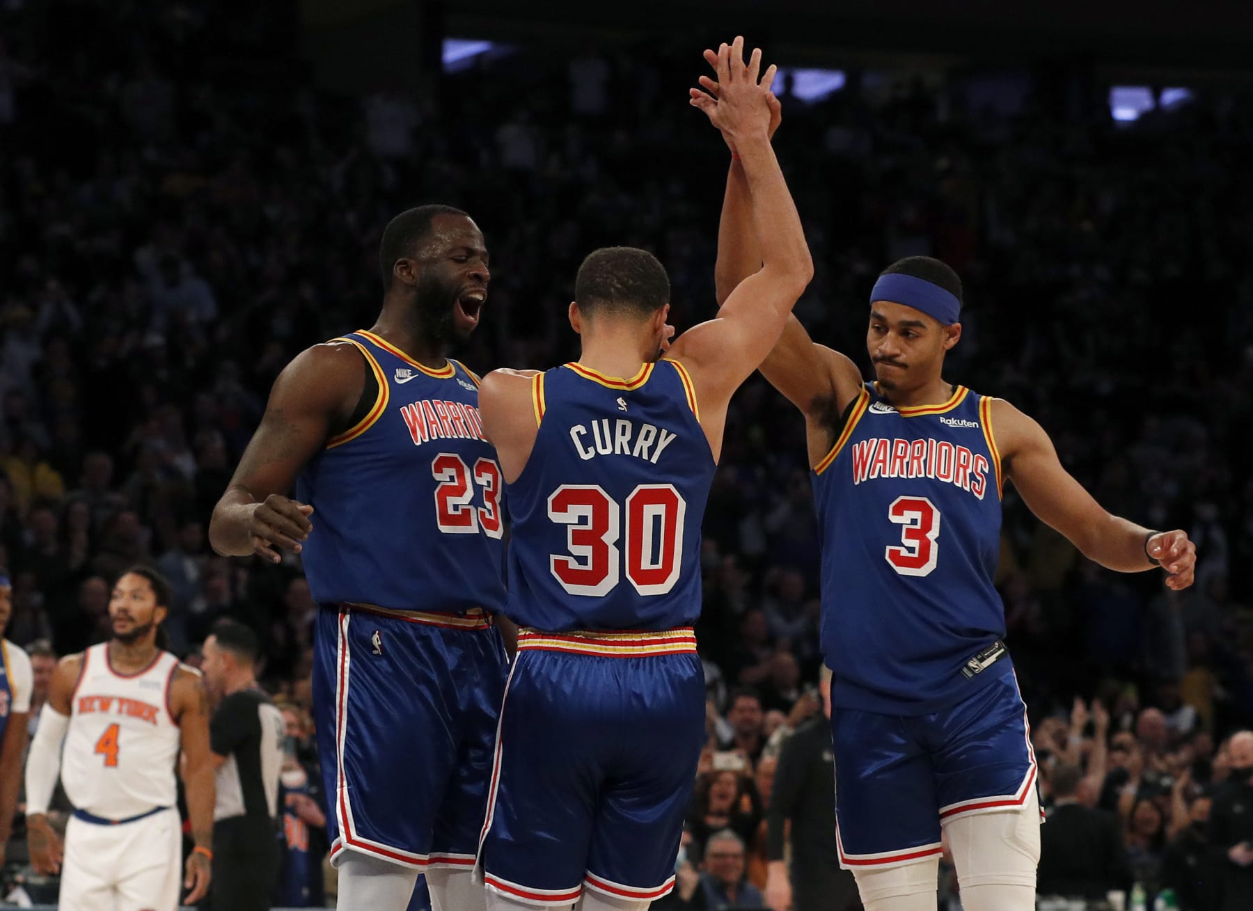 NEW YORK, NEW YORK - DECEMBER 14: (NEW YORK DAILIES OUT) Stephen Curry #30 of the Golden State Warriors reacts with teammates Draymond Green #23 and Jordan Poole #3 after shooting a three point basket to become the NBA's all-time leader during the first quarter against the New York Knicks at Madison Square Garden on December 14, 2021 in New York City. Curry passed ray Allen with his 2,974th three pointer. The Warriors defeated the Knicks 105-96. NOTE TO USER: User expressly acknowledges and agrees that, by downloading and or using this photograph, user is consenting to the terms and conditions of the Getty Images License Agreement. (Photo by Jim McIsaac/Getty Images)