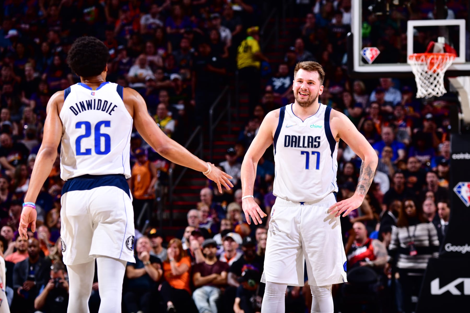 PHOENIX, AZ - MAY 2: Spencer Dinwiddie #26 and Luka Doncic #77 of the Dallas Mavericks embrace during Game 1 of the 2022 NBA Playoffs Western Conference Semifinals on May 2, 2022 at Footprint Center in Phoenix, Arizona. NOTE TO USER: User expressly acknowledges and agrees that, by downloading and or using this photograph, user is consenting to the terms and conditions of the Getty Images License Agreement. Mandatory Copyright Notice: Copyright 2022 NBAE (Photo by Barry Gossage/NBAE via Getty Images)