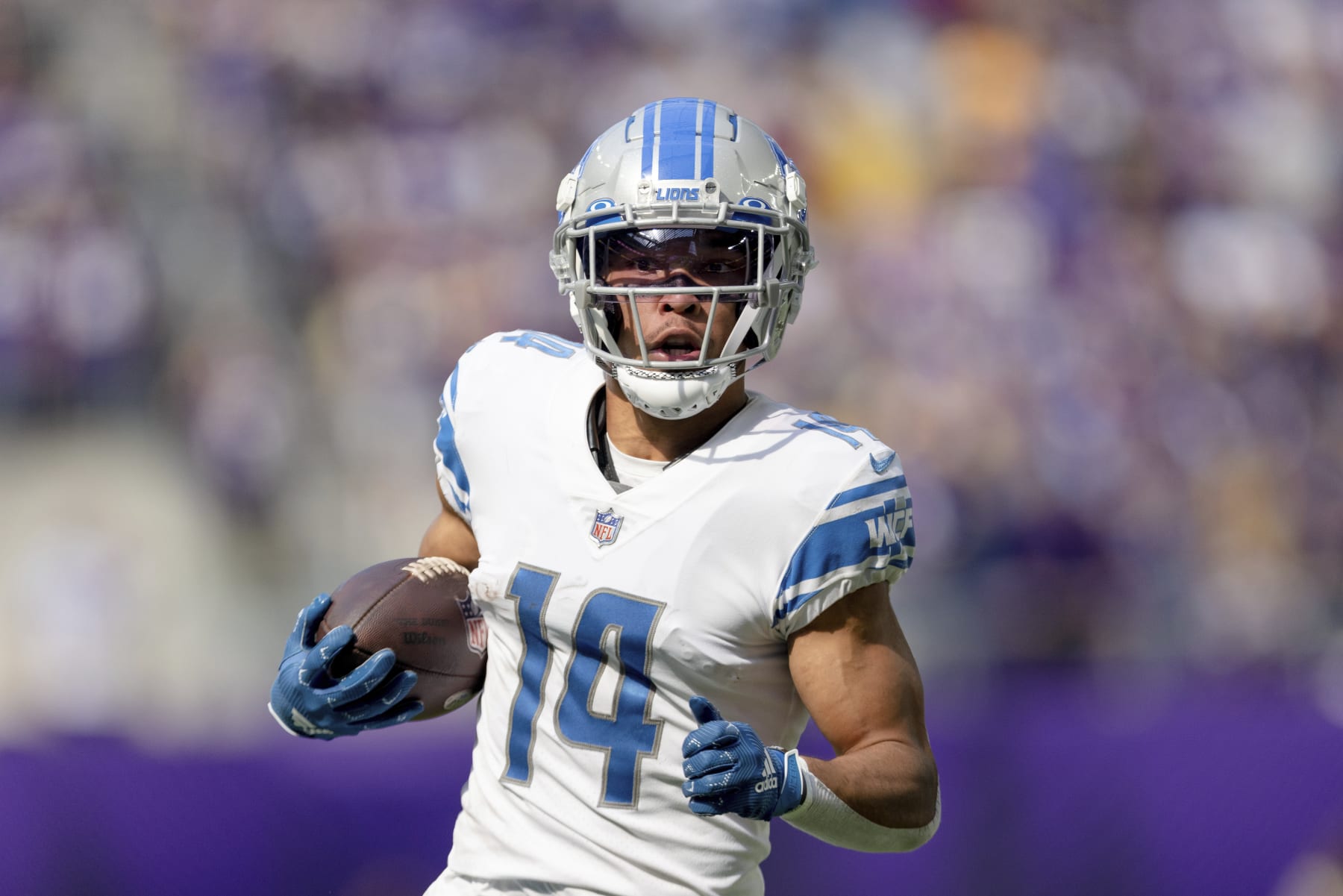 Detroit Lions wide receiver Amon-Ra St. Brown (14) carries the ball during the first half of an NFL football game against the Minnesota Vikings, Sunday, Sept. 25, 2022 in Minneapolis. (AP Photo/Stacy Bengs)