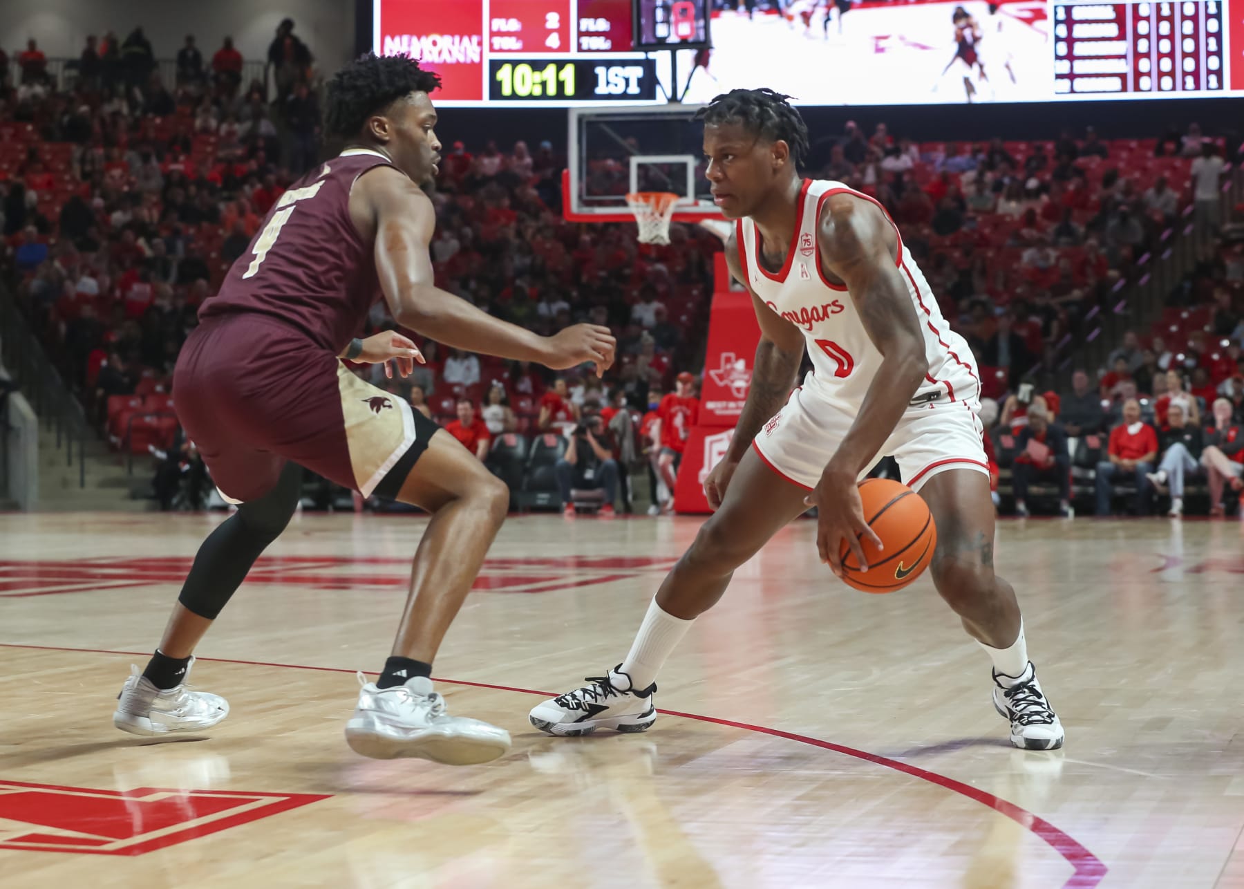 HOUSTON, TX - DECEMBER 22: Houston Cougars guard Marcus Sasser (0) drives the ball past Texas State Bobcats guard Shelby Adams (4) in the first half during the college basketball game between the Texas State Bobcats and Houston Cougars on December 22 at Fertitta Center in Houston, Texas. (Photo by Leslie Plaza Johnson/Icon Sportswire via Getty Images)