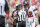 Line judge Rusty Baynes (59) speaks with Tampa Bay Buccaneers quarterback Tom Brady (12) during the first half of an NFL football game against the Atlanta Falcons, Sunday, Oct. 9, 2022, in Tampa, Fla. (AP Photo/Mark LoMoglio)